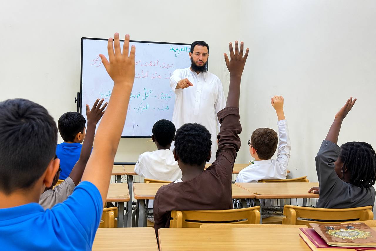 Students raising their hands during a Fusha Arabic lesson at SAF One Education
